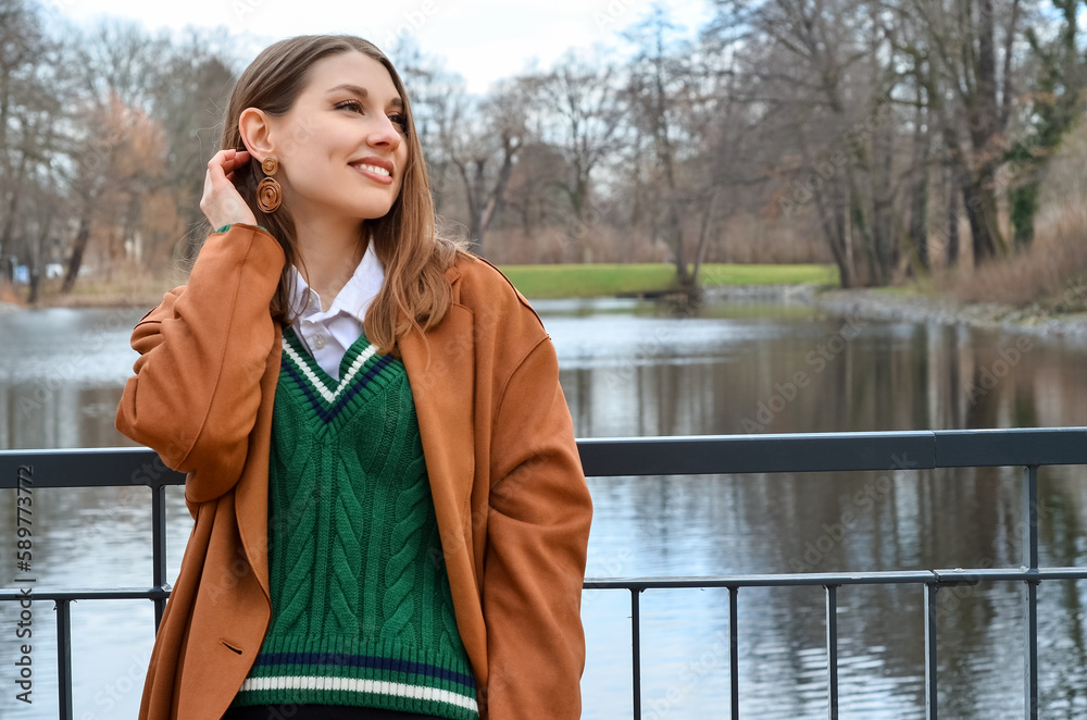 Stylish young woman on embankment