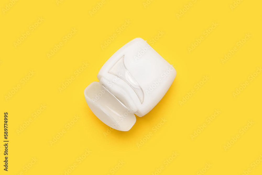 Case with dental floss on yellow background