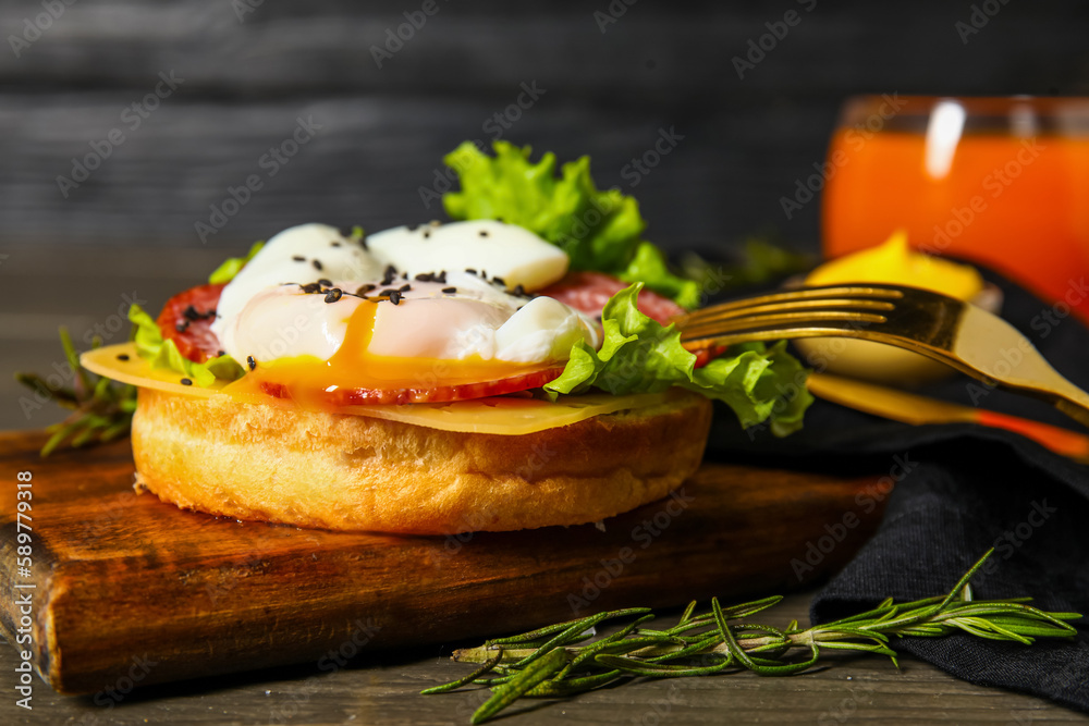 Board with tasty egg Benedict on table, closeup