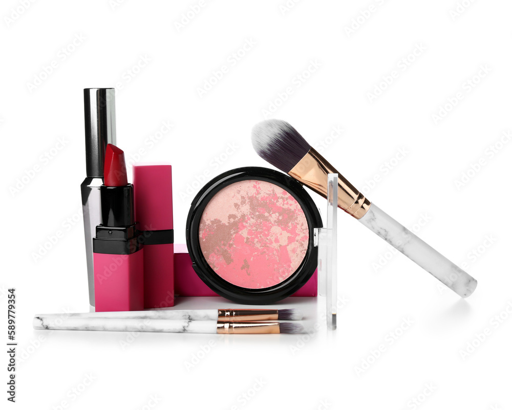 Decorative cosmetics with brushes on white background