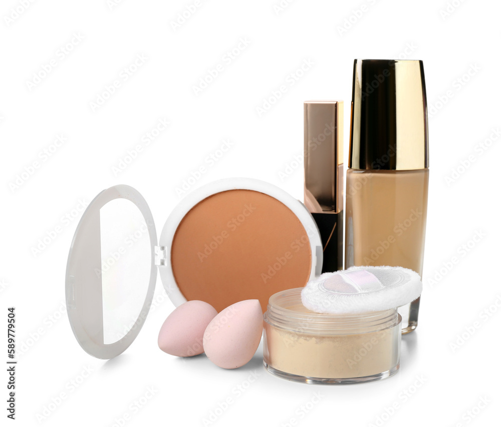 Decorative cosmetics with sponges on white background