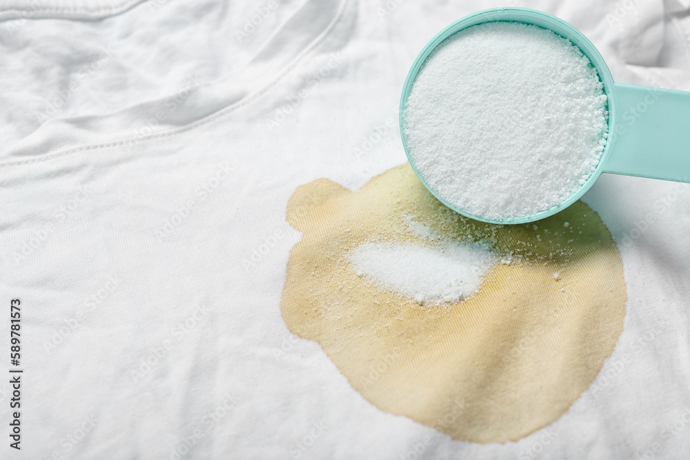 Laundry detergent on stained t-shirt, closeup