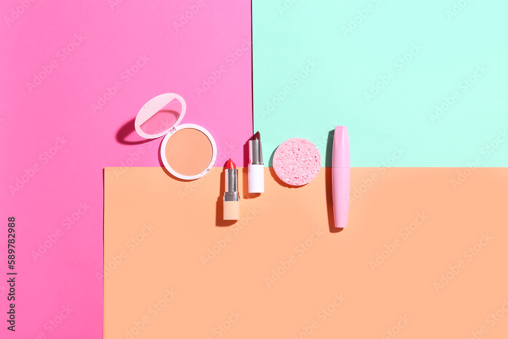 Decorative cosmetics with makeup sponge on color background