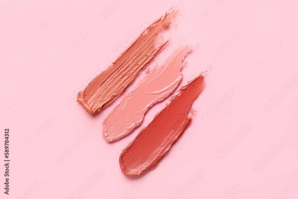 Different lipstick strokes on pink background