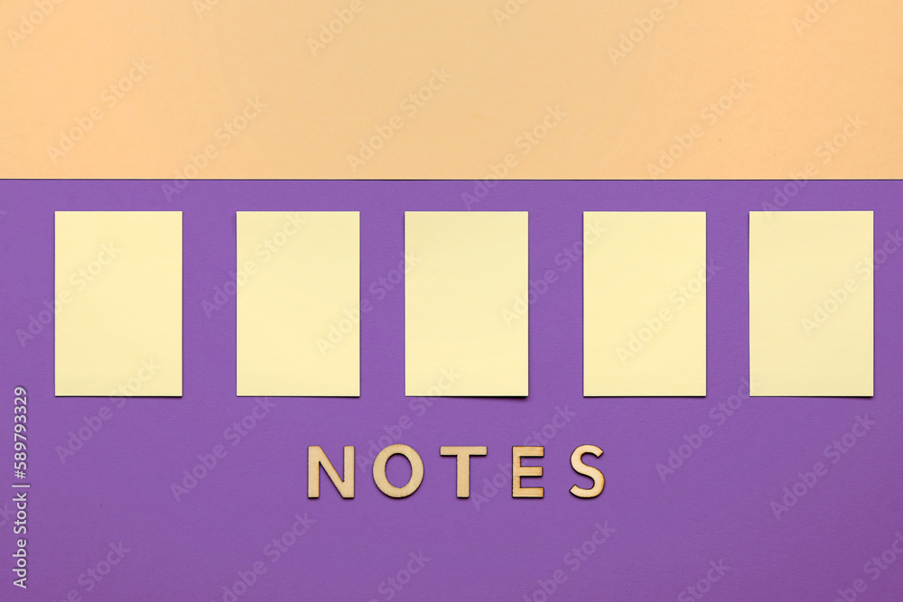 Word NOTES and sticky papers on color background