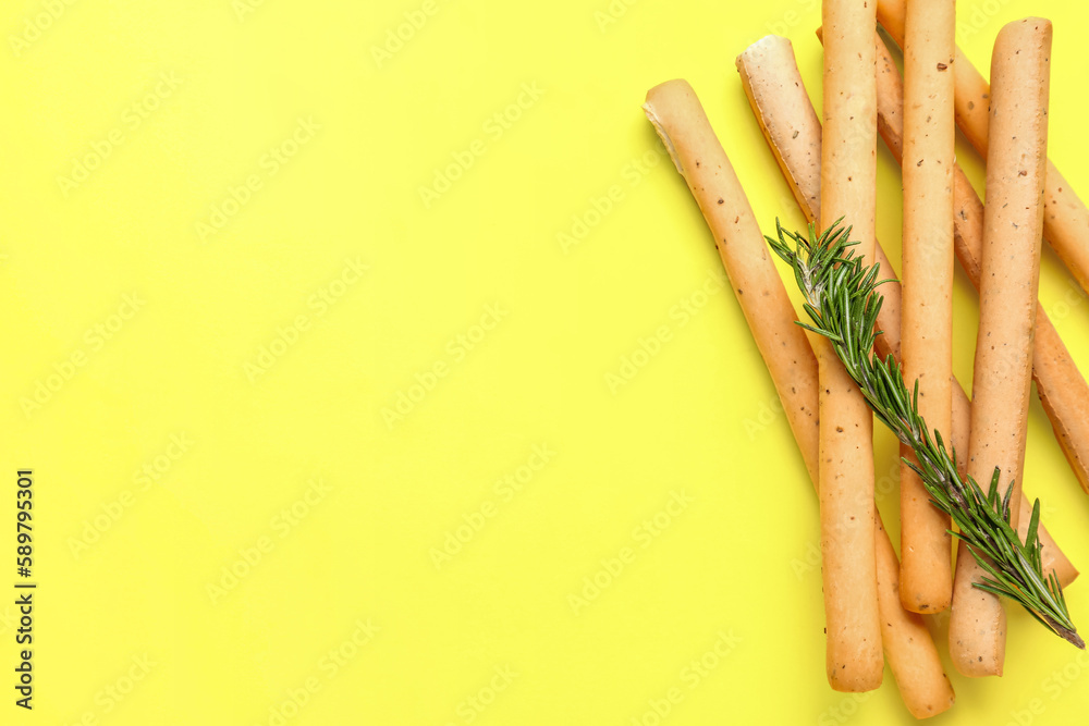 Tasty Italian Grissini on yellow background