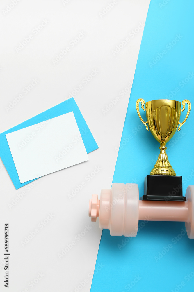 Blank card with gold cup and dumbbell on color background