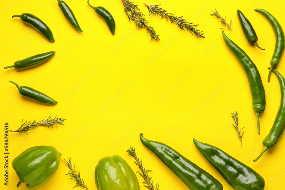 Frame made of green peppers and rosemary on yellow background