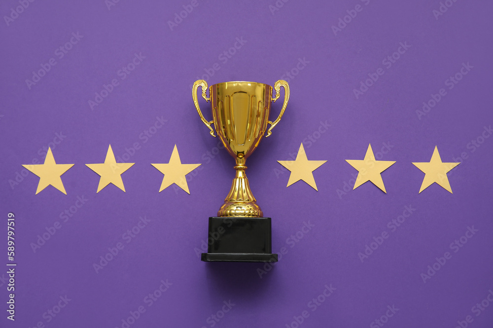 Gold cup with stars on purple background