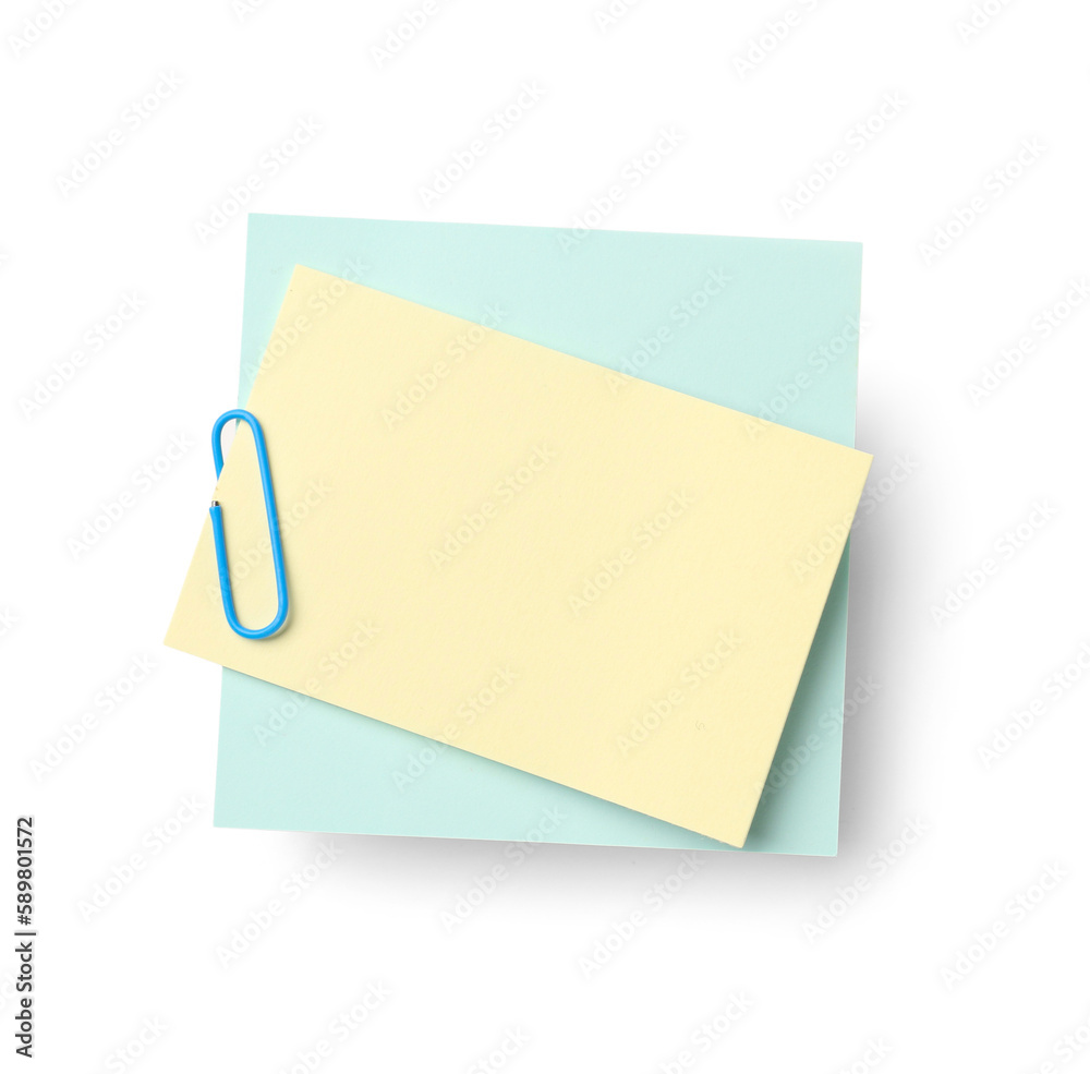 Yellow and blue sticky notes with paper clip on white background