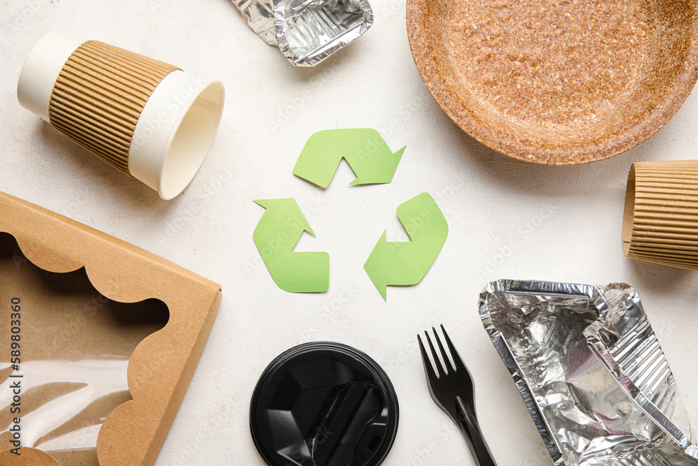 Recycling sign with garbage on white background