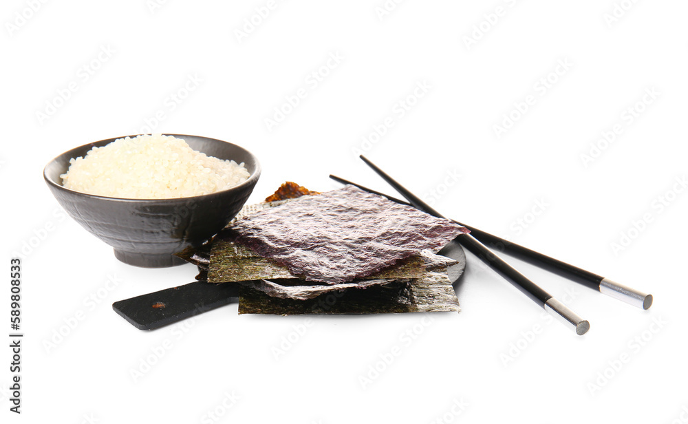 Board with natural nori sheets, chopsticks and bowl of rice isolated on white background