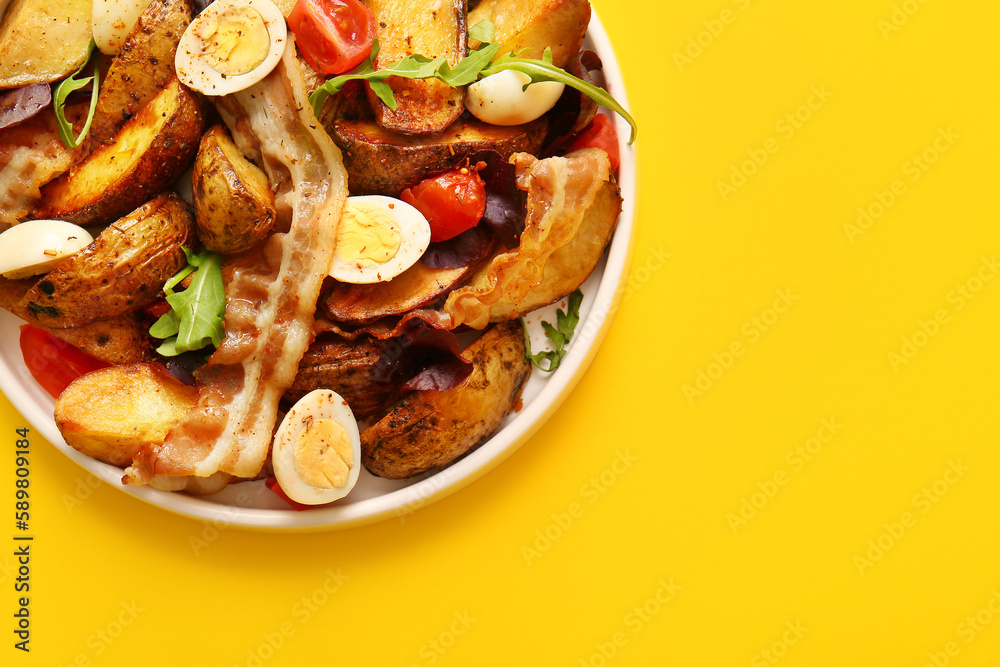 Plate of tasty potato salad with eggs, tomatoes and bacon on yellow background, top view