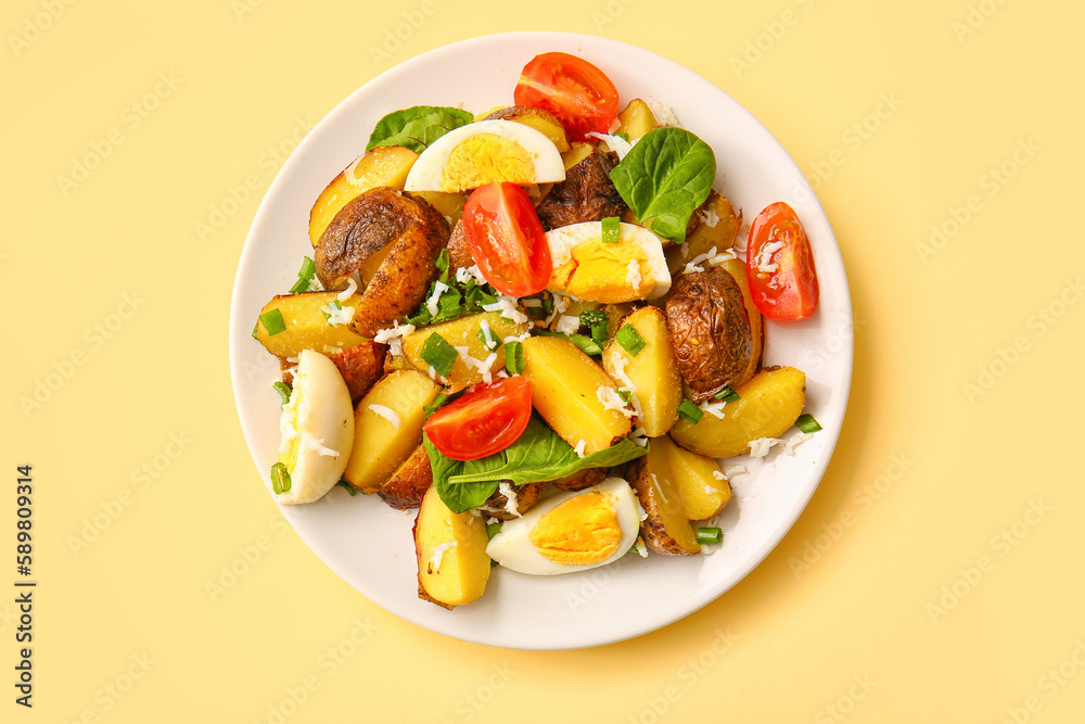 Plate of tasty potato salad with eggs and tomatoes on beige background, top view