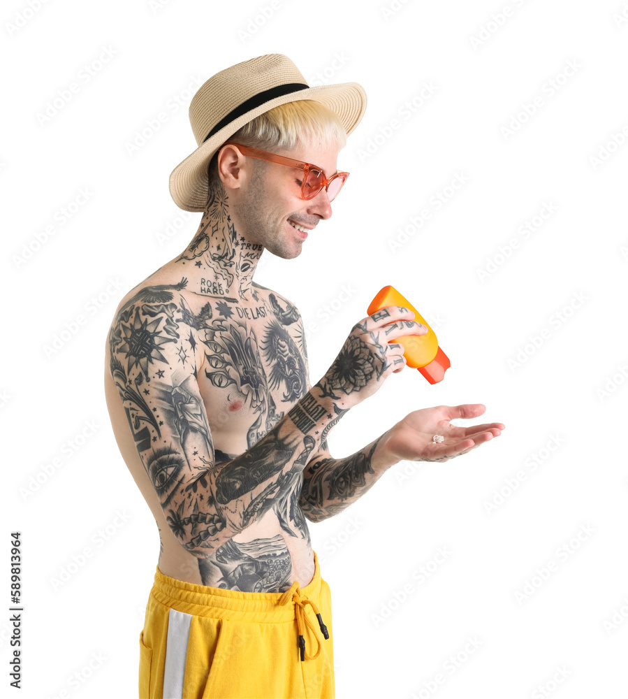 Tattooed man with sunscreen cream on white background