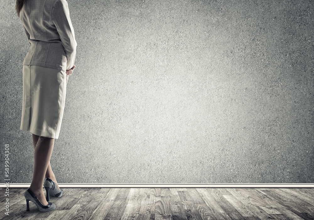 Businesswoman looking at wall