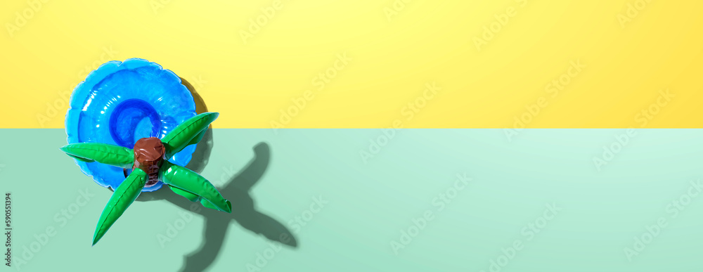 Summer concept with a palm tree float overhead view - flat lay