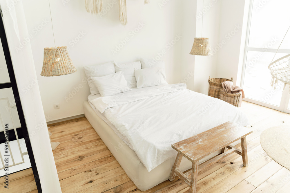 a beautiful bright room with a large bed and a white bed. eco style interior. wooden floor. beautifu