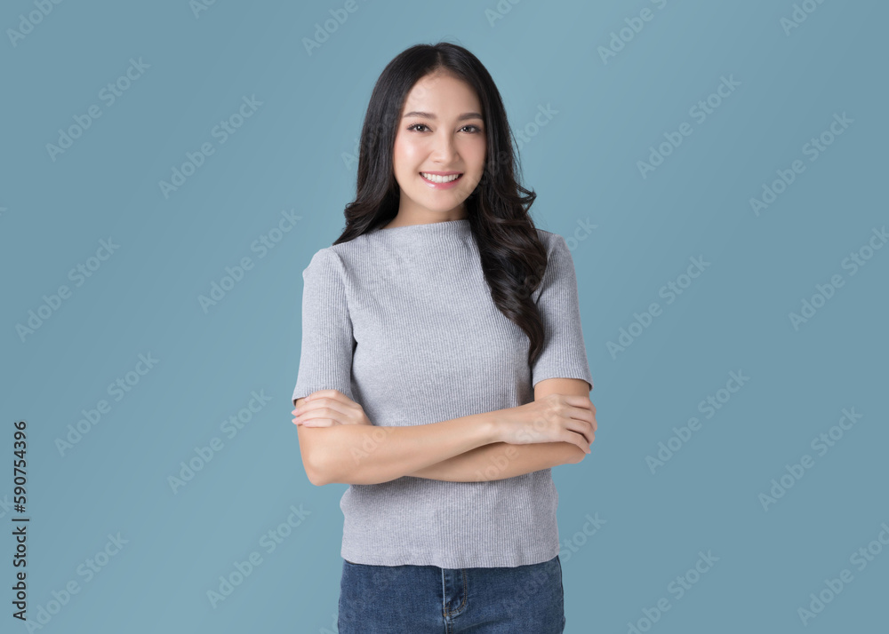 Portrait beautiful Asian woman in sweater and blue jeans isolated over cyan background