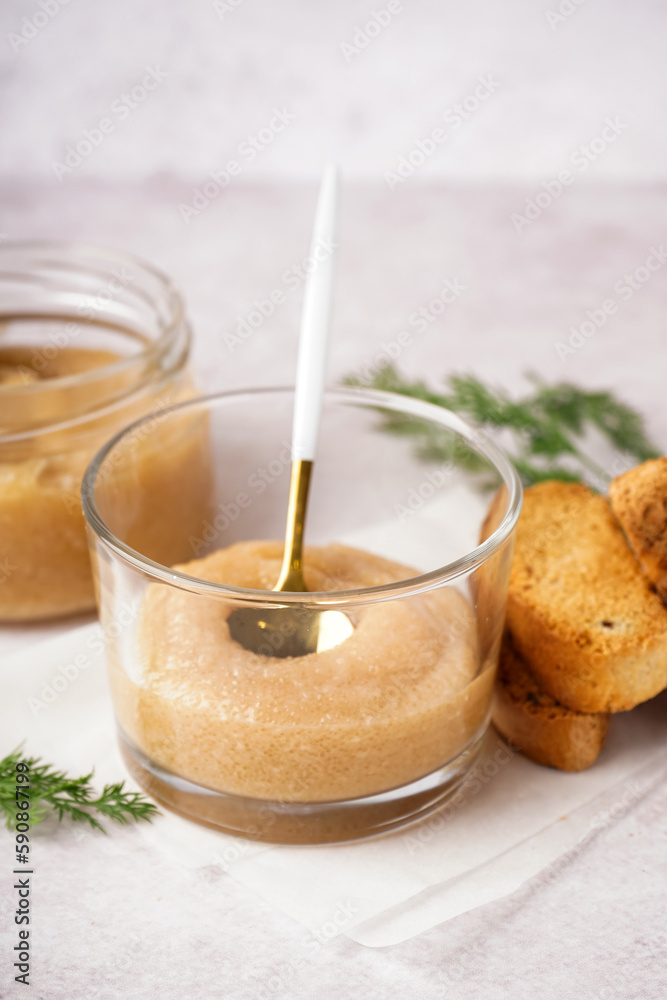 Glass with delicious caviar of capelin on white background