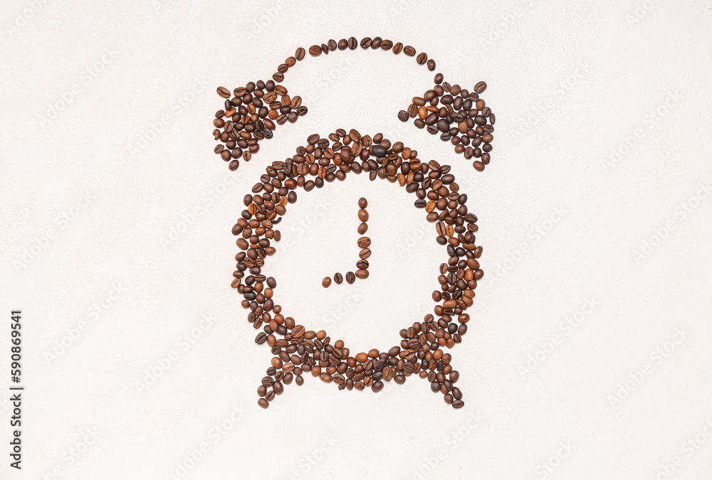 Alarm clock made of coffee beans on light background