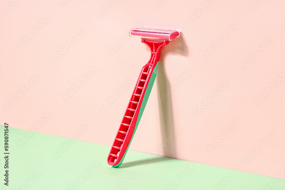 Safety razor for hair removal on color background