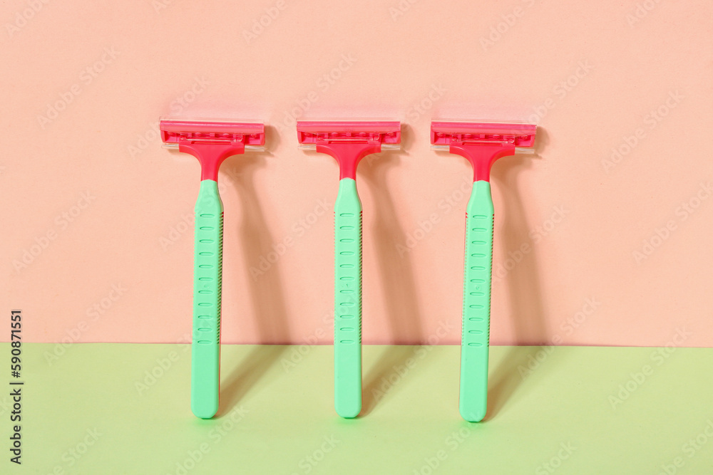 Set of safety razors for hair removal on color background