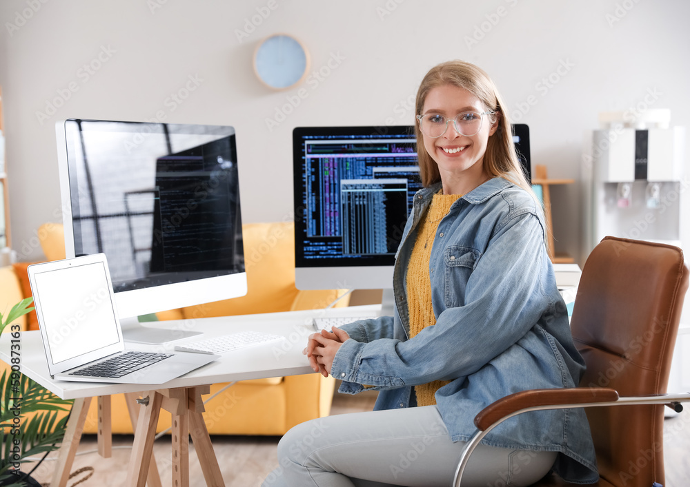 Female programmer working at table in office