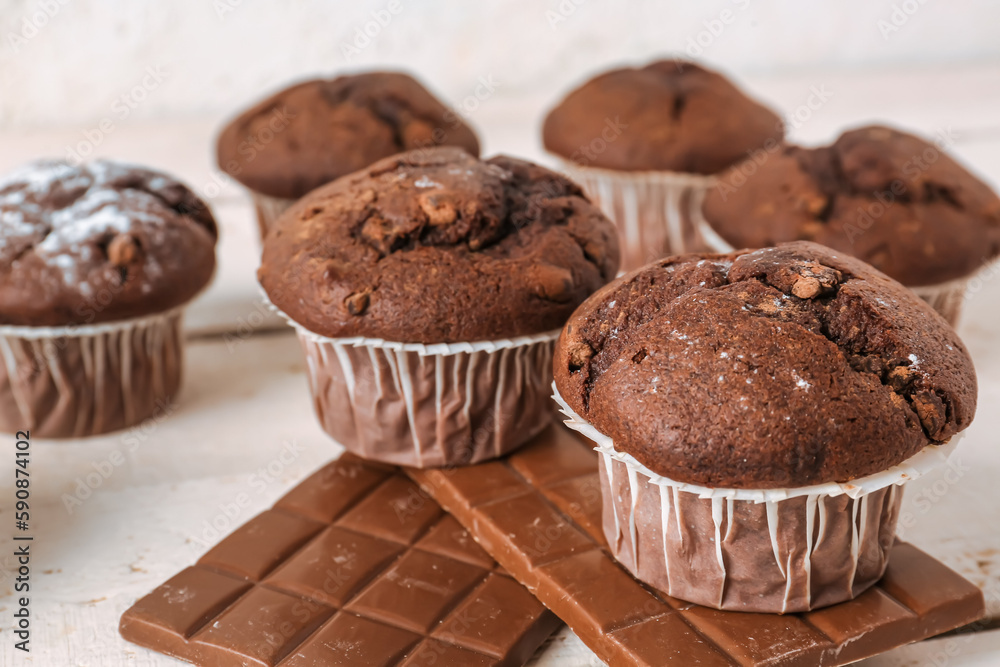 Tasty chocolate cupcakes on table