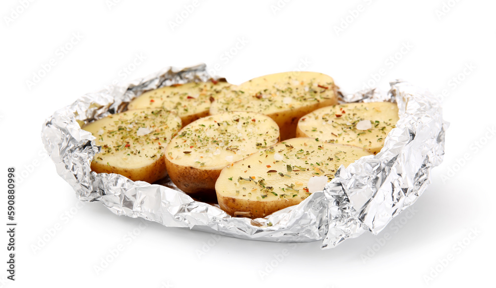 Raw potato with spices wrapped in aluminium foil on white background