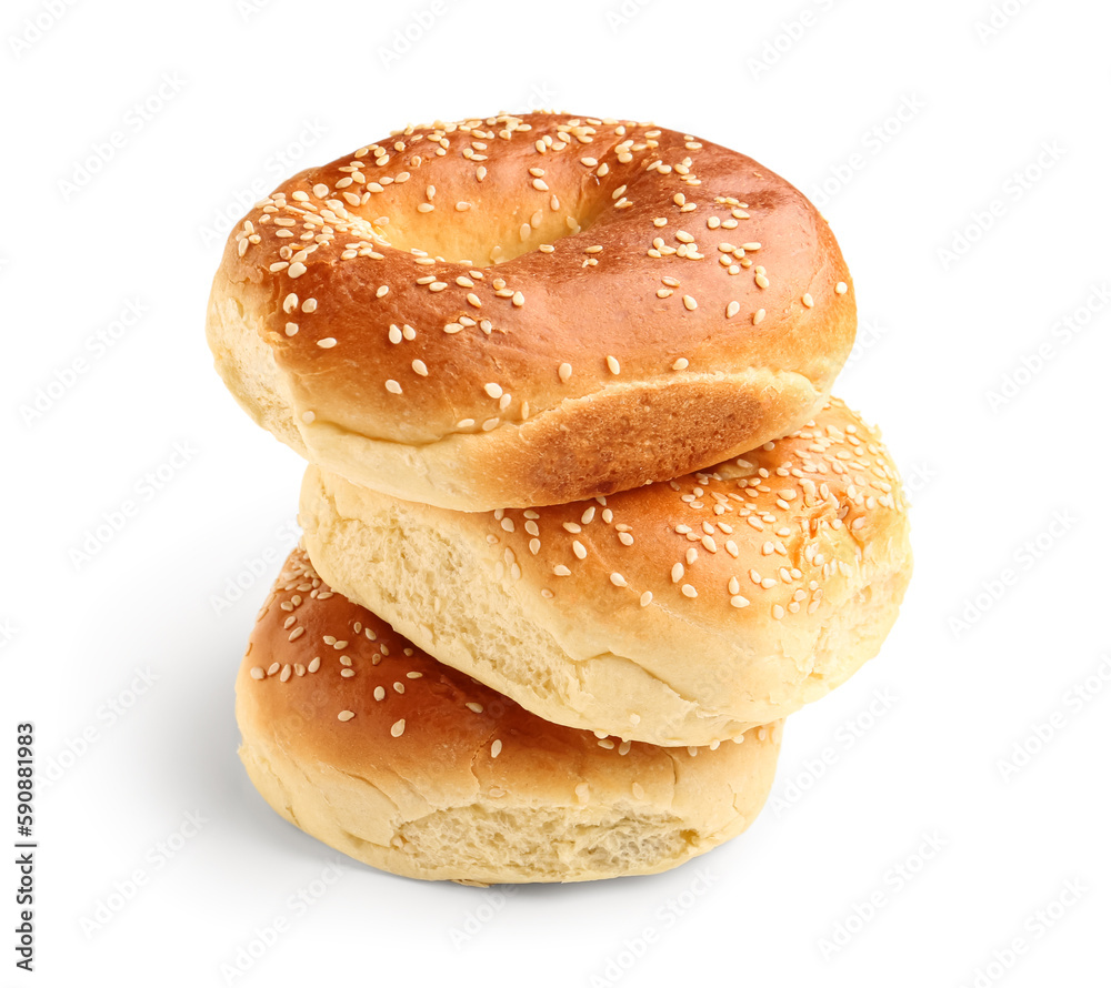 Tasty bagels with sesame seeds on white background