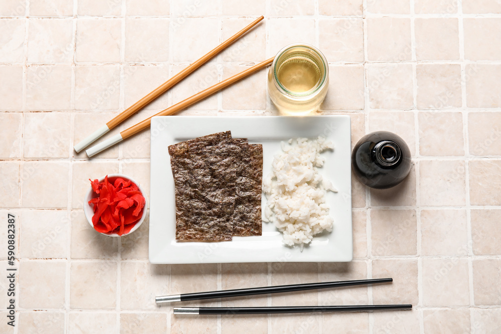 Composition with ingredients for preparing sushi rolls on light tile background