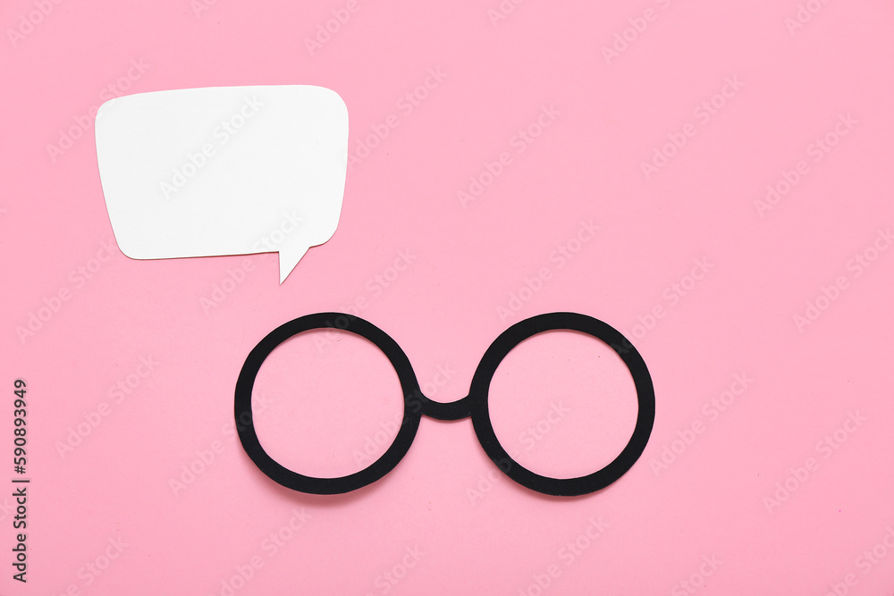 Paper eyeglasses with speech bubble on pink background. Dialogue concept