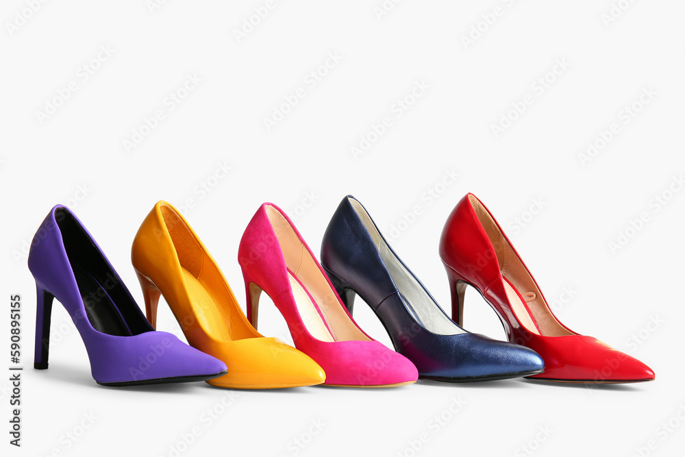 Fashionable high heeled shoes on light background