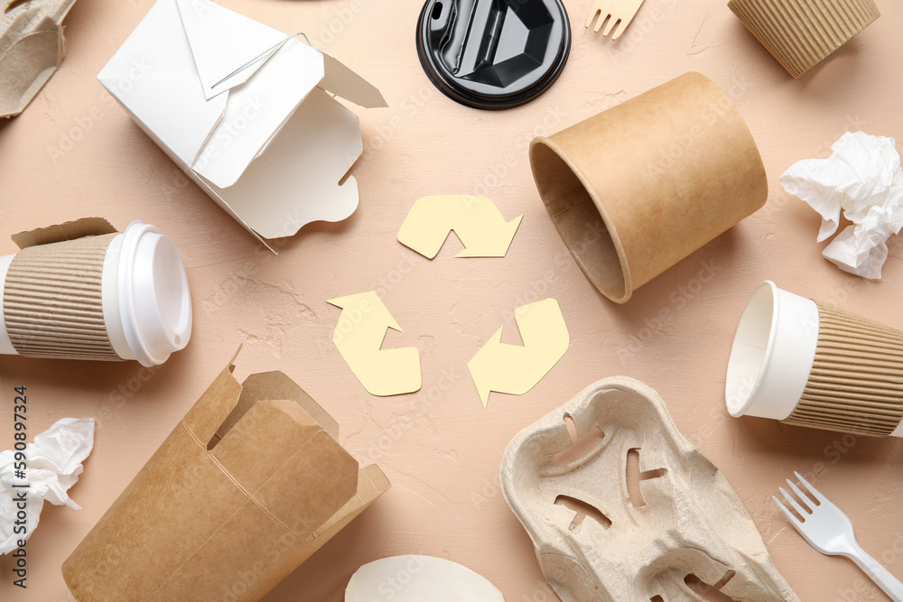 Recycling sign with garbage on beige background