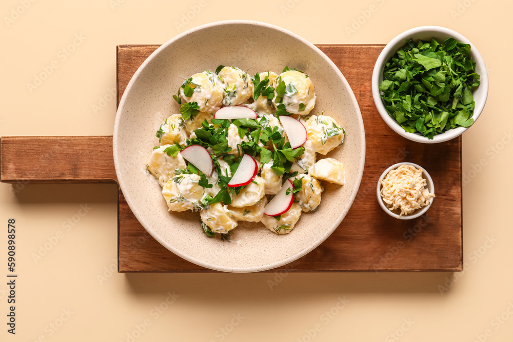 Plate of tasty Potato Salad with greens on yellow background