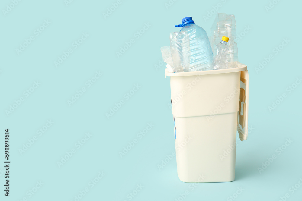 Container for garbage with plastic on light blue background. Recycling concept