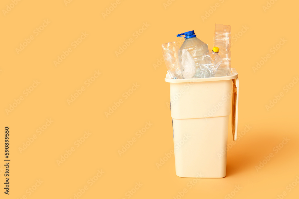 Container for garbage with plastic on beige background. Recycling concept