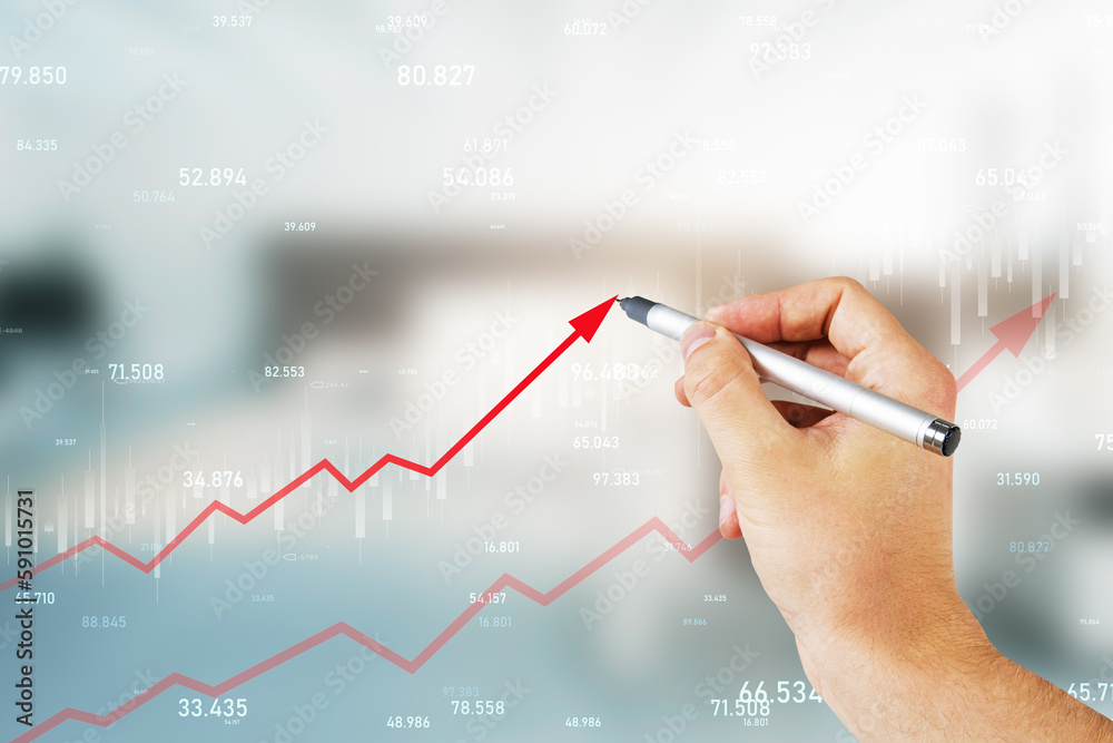 Close up of male hand drawing growing red business chart arrow on blurry office interior background.