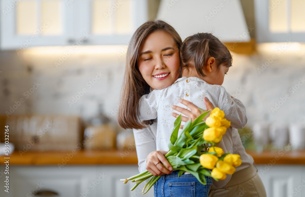 Daughter giving mother bouquet of flowers.