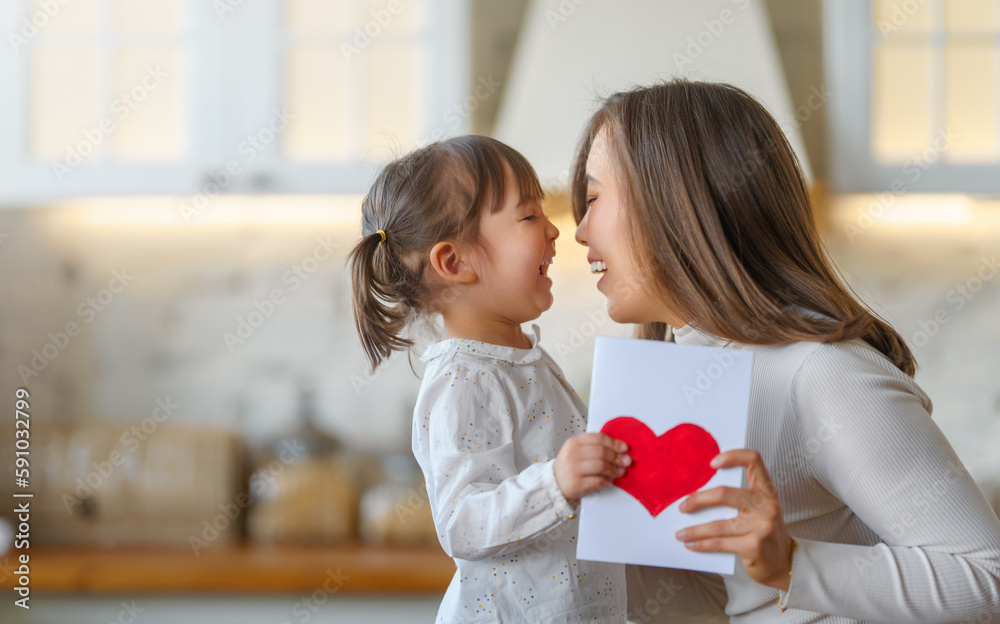 Daughter giving mother postcard