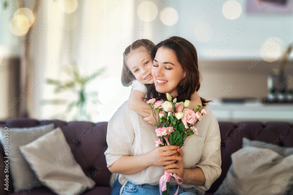 Daughter giving mother bouquet of flowers.