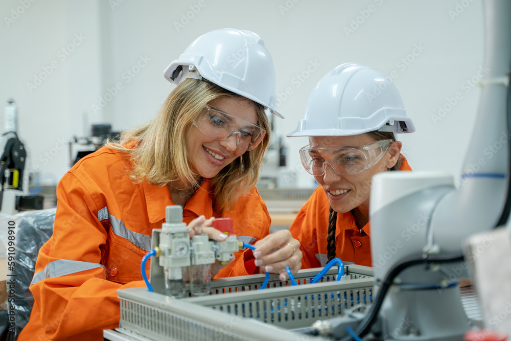 Engineer checking and operation robot arm at factory,Technology, automation,Innovation and engineeri