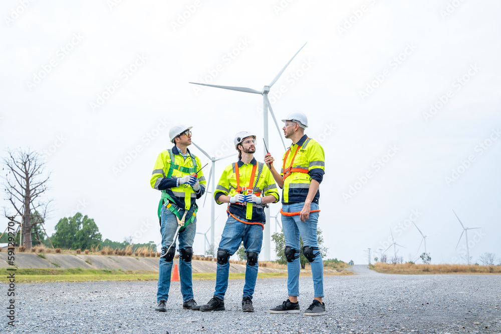 Engineer working at renewable energy farm,Inspector controlling functioning of wind turbines outdoor