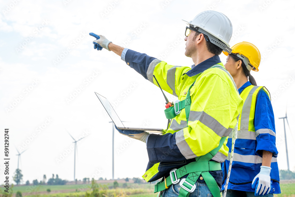 Engineer working at windmill farm,Generating electricity clean energy.