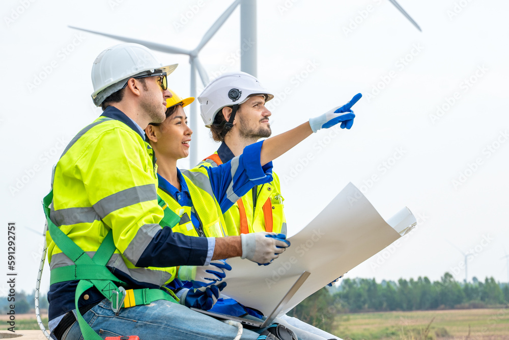 Technician Engineer in uniform are checking wind turbine power farm, Power generator station,Clean e