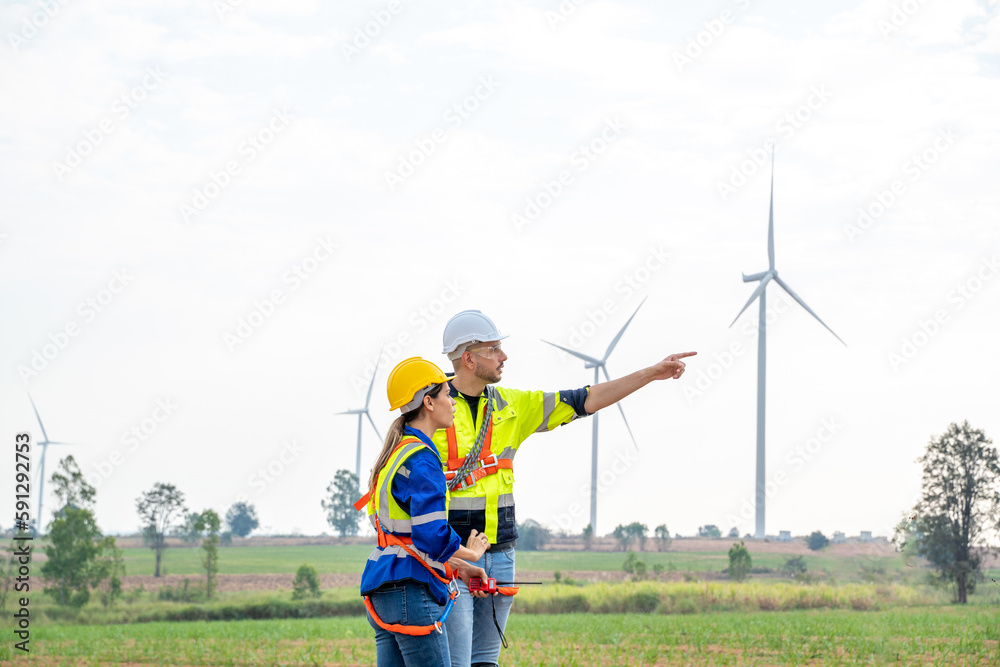 Engineer working at windmill farm,Generating electricity clean energy.