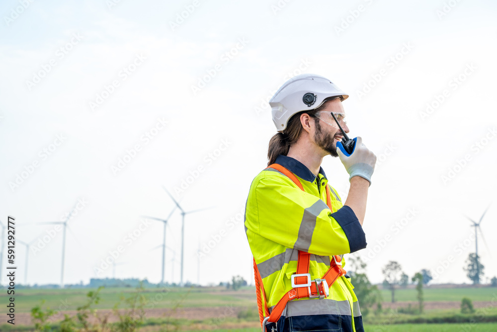 Engineer checking control electric power at windmill farm,Generating electricity clean energy.