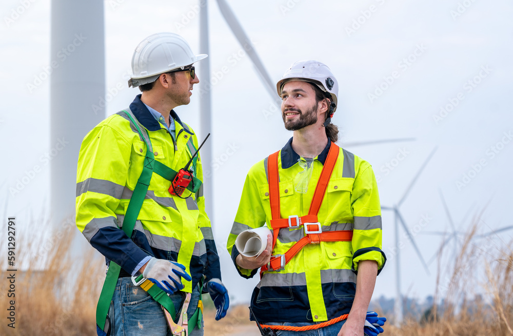 Technician Engineer in uniform are checking wind turbine power farm, Power generator station,Clean e