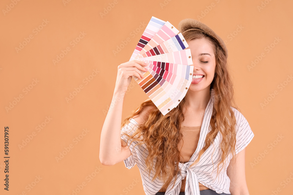 Female artist with paint color palettes on beige background